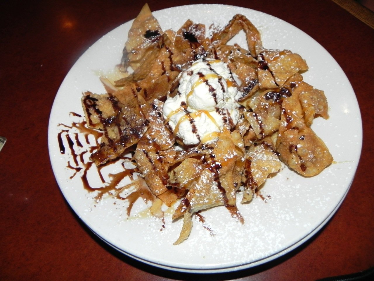 Dessert nachos with ice cream, caramel and chocolate sauce