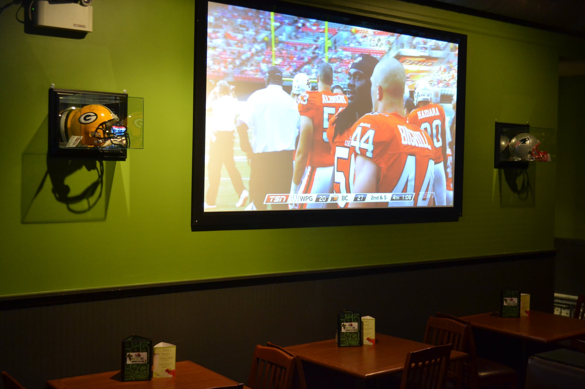 Dining room at The Gator's Tail with the big screen showing the game